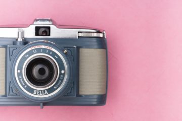 gray and silver camera on pink surface